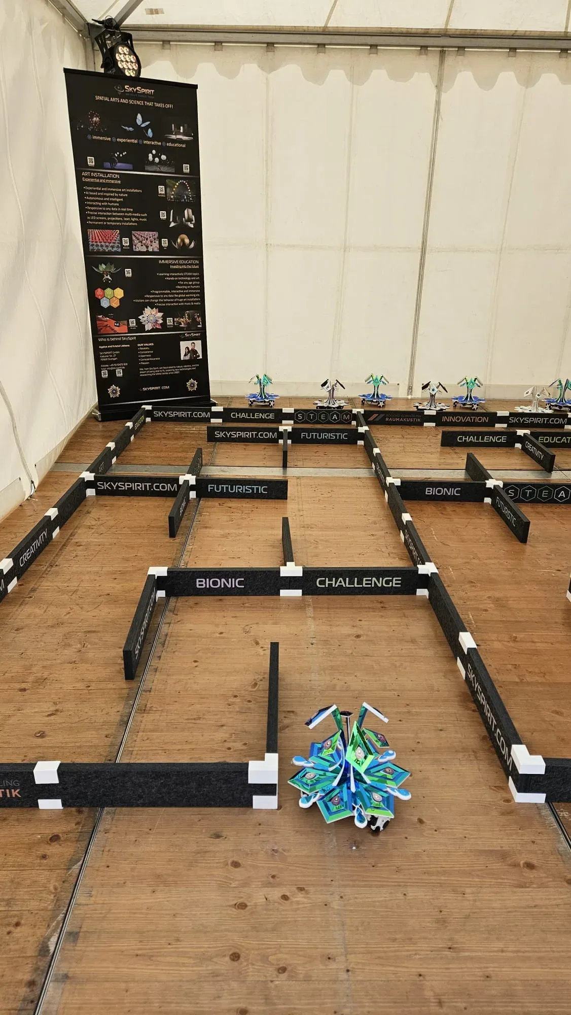 Looking along the maze corridors, with a blossom robot at the start