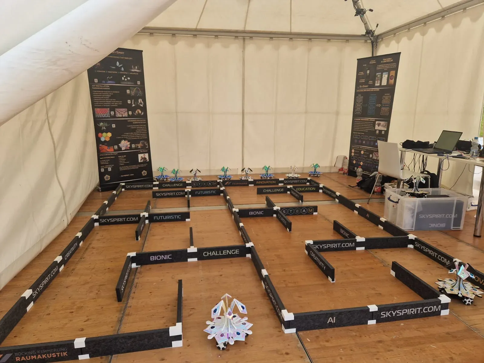 The maze seen from above, with a row of blossom robots lined up along the back wall